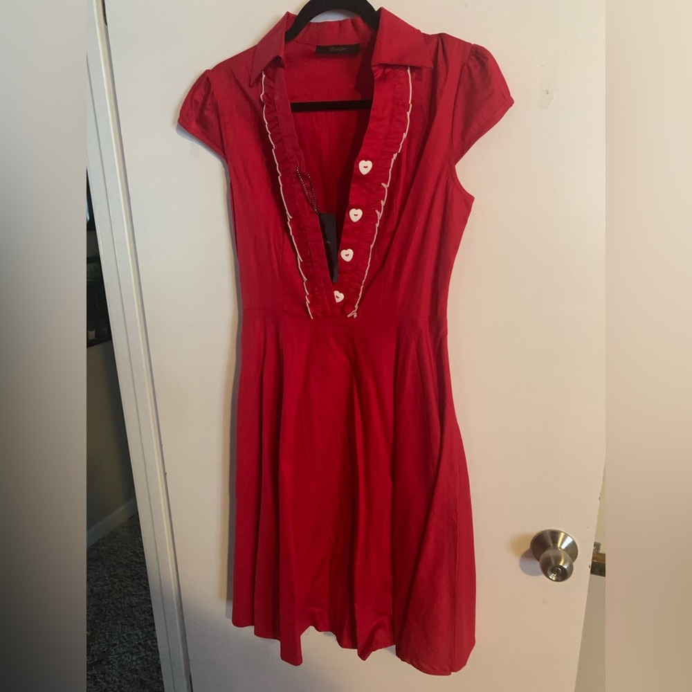 Adorable red dress with heart buttons. Never worn.